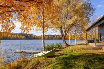 Aulanko Lake Villa's pier, boat, and terrace overlooking the shores of Lake Aulangonjärvi.