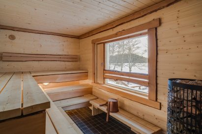 The sauna room of Aulanko Grand Villa's lakeshore sauna, with a view overlooking Lake Aulangonjärvi.