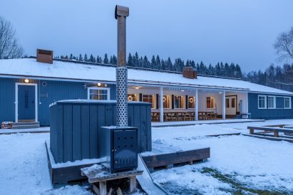 The front yard of Aulanko Grand Villa on a winter evening. In the foreground, a wood-fired hot tub.