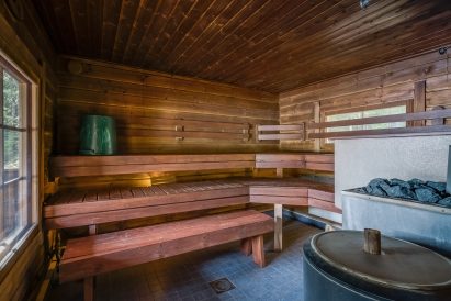 The spacious hot room of Evo Syväjärvi's traditional wood-heated sauna.