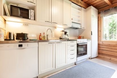 The open kitchen, which is an extension of the main hall of Evo Wilderness Villa, is equipped with a dishwasher, microwave, coffee maker and water kettle, toaster, electric stove/oven and fridge/freezer.