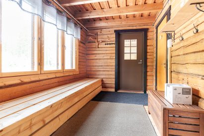 Dressing room of Evo Wilderness Villa's indoor sauna compartment. The door provides a direct access to the sheltered terrace.
