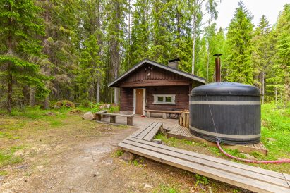 In front of Evo Wilderness Villa's wood-heated outdoor sauna is another of the wood-heated hot tubs.