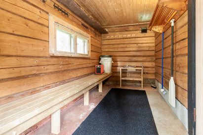 The dressing room of the traditional wood-heated sauna located in Evo Wilderness Villa's backyard. During the winter, the dressing room is heated by an electric fan.