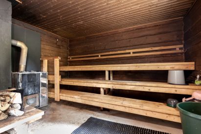 The atmospheric hot room of the traditional wood-heated sauna located in the courtyard of Evo Wilderness Villa.