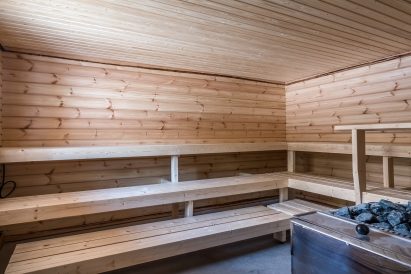 The atmospheric hot room of the wood-heated outdoor sauna at Tavastia Privacy.