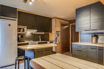 The open kitchen at Tavastia Privacy is equipped with a refrigerator/freezer, microwave, coffee maker, stove/oven, and dishwasher.