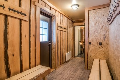 The dressing room of the indoor sauna section at Tavastia Privacy, providing direct access to the covered outdoor terrace and the warmth of the hot tub.