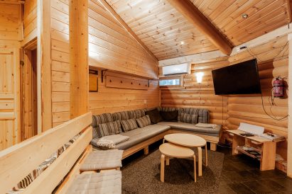 The lounge corner of Loppi Wilderness Villa's main hall, whose sofa can also be used as an extra bed.