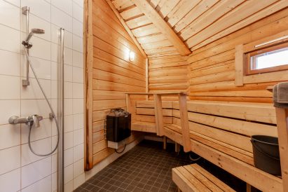 The spacious electric heated indoor sauna of Loppi Wilderness Villa.