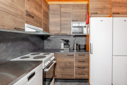 The kitchen at Loppi Luxus is equipped with a dishwasher, stove/oven, coffee maker and water kettle, toaster, microwave, refrigerator, and refrigerator/freezer.