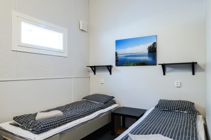 The second bedroom behind the main hall at Räyskälä Grand Villa.