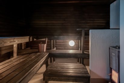 One of the three saunas in the lower floor of Räyskälä Grand Villa is a traditional wood-heated sauna.