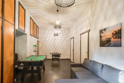 Another game lounge on the ground floor of Räyskälä Grand Villa. The sofa can be used as an additional bed if needed.