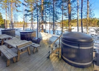 On the lakeside open terrace of Räyskälä Grand Villa, there are 3 wood-heated hot tubs.