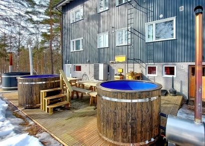 On the lakeside open terrace of Räyskälä Grand Villa, there are 3 wood-heated hot tubs.