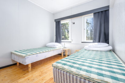The double bedroom (Room 13) of the separately rentable west wing corner apartment at Räyskälä Grand Villa.