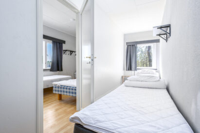 Upstairs sleeping lobby at Räyskälä Grand Villa, featuring 2 beds.